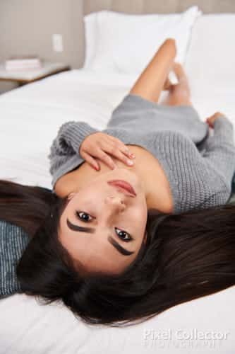 woman laying on her back on the bed