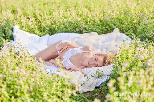 woman laying down during a hay field boudoir session