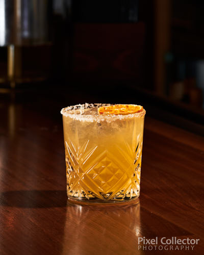 Food photography of a mixed drink on the bar.