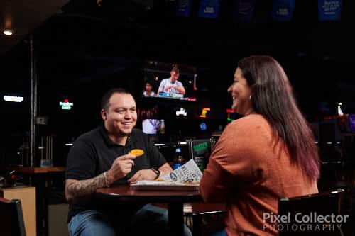 A couple eating food at Clicks Billiards.