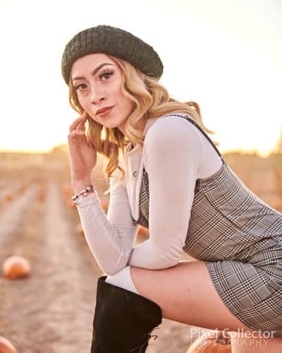 Sitting on a pumpkin during her glamour photography session.