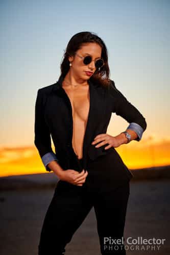 Wearing a suit in front of the sunset.