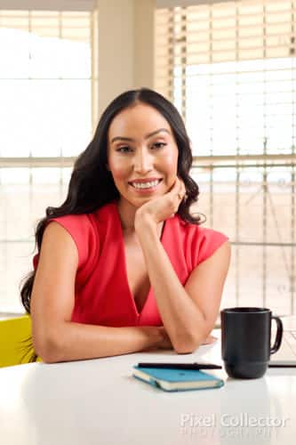 Headshot showing pleasant smile of woman working from home.