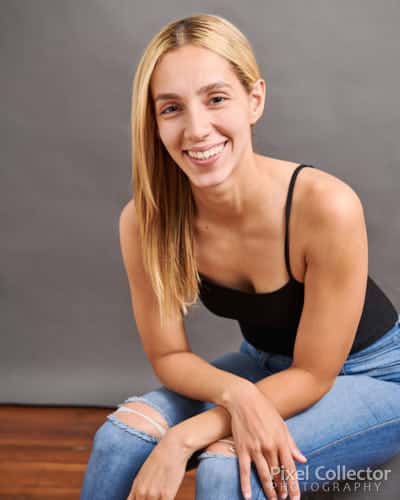 Woman sitting and smiling at the camera.